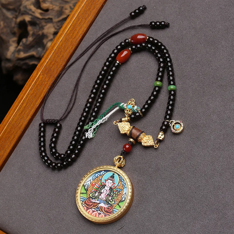 Tibetan-style collectible, hand-painted thangka pendant featuring the Bodhisattva Mahāsthāmaprāpta, with a red agate and coconut
Tibetan-style collectible, hand-painted thangka pendant featuring the Bodhisattva Mahāsthāmaprāpta, with a red agate and coconut