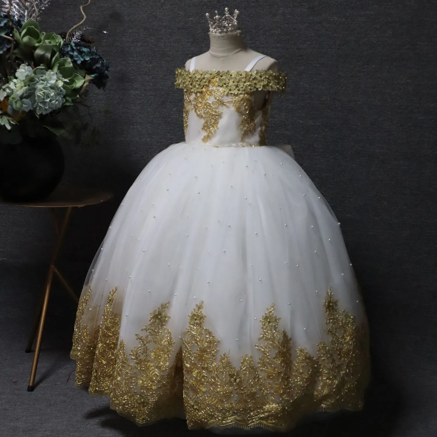 White one-line shoulder strap long floral children's dress, multi-layer mesh design, gold applique pattern
White one-line shoulder strap long floral children's dress, multi-layer mesh design, gold applique pattern