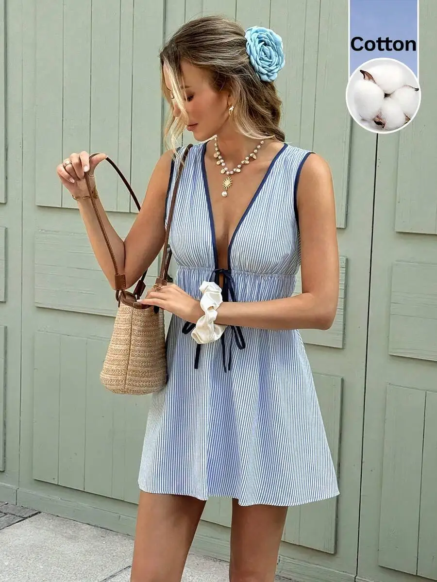 Sleeveless Blue-White Striped Cotton Mini Dress With Deep V-Neck, Contrast Binding, Smocked Waist, And Front Tie For Summer
Sleeveless Blue-White Striped Cotton Mini Dress With Deep V-Neck, Contrast Binding, Smocked Waist, And Front Tie For Summer