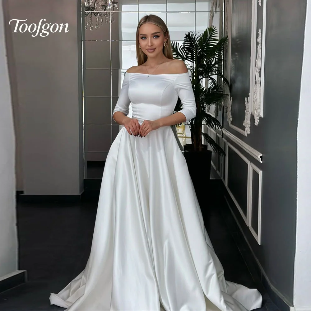 Toofan Boat Neck Half Sleeve A Line Свадебные платья Индивидуальное драпированное атласное элегантное платье невесты с открытой спиной в пол свадебное платье 2025
Toofan Boat Neck Half Sleeve A Line Свадебные платья Индивидуальное драпированное атласное элегантное платье невесты с открытой спиной в пол свадебное платье 2025