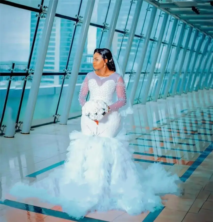 Customized Scoop Neck Shinny Pearls Wedding Dress Robe De Mariée Arabic Full Sleeves Multi Tiers Tulle Mermaid Bridal Gown
Customized Scoop Neck Shinny Pearls Wedding Dress Robe De Mariée Arabic Full Sleeves Multi Tiers Tulle Mermaid Bridal Gown