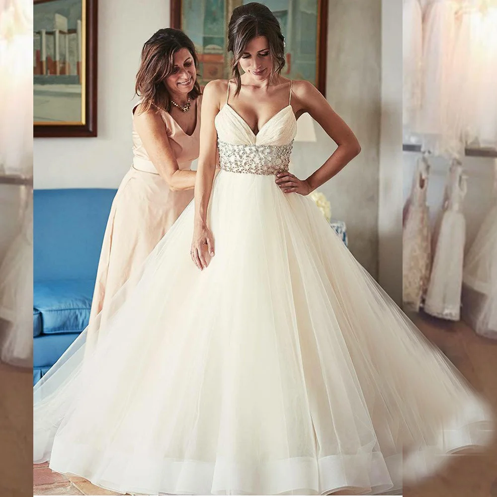 Charming Beaded Tulle Ball Gown Wedding Dresses with Spahetti Straps Crystal Puffy Princess Backless Bridal Gowns
Charming Beaded Tulle Ball Gown Wedding Dresses with Spahetti Straps Crystal Puffy Princess Backless Bridal Gowns