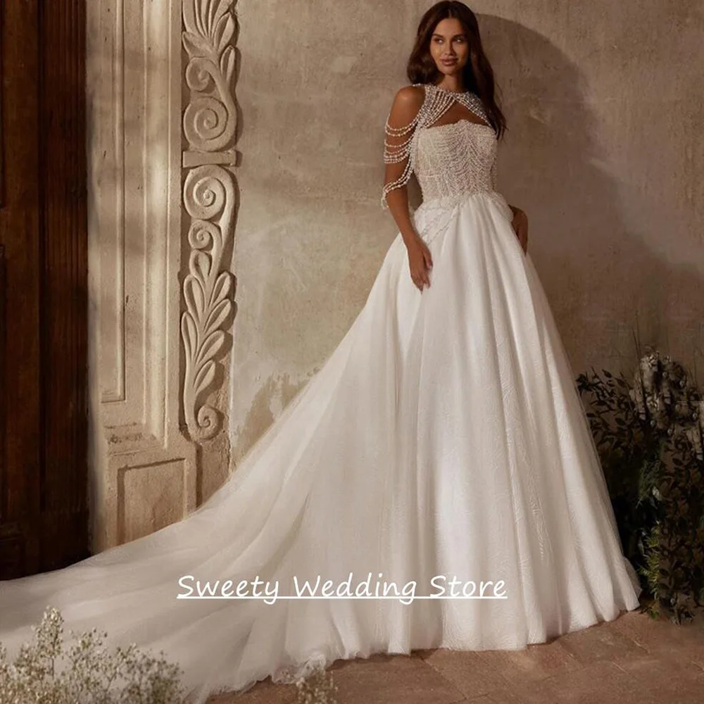 Luxury Pearls Wedding Dress Customized Strapless Sleeveless Pearls See Through Court Train Glitter Bridal Gown for Bride
Luxury Pearls Wedding Dress Customized Strapless Sleeveless Pearls See Through Court Train Glitter Bridal Gown for Bride