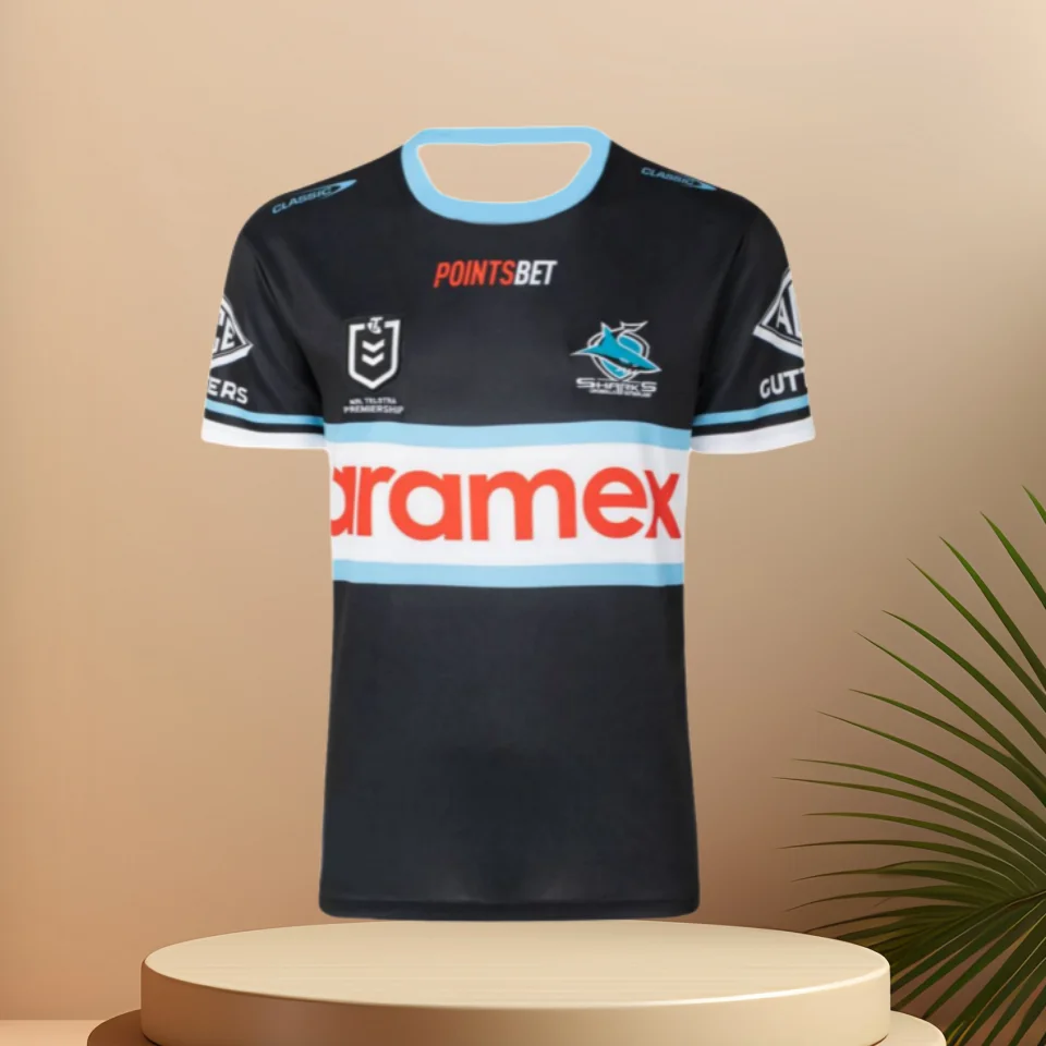 Лето 2025 г., новинка, горячая распродажа, фирменный трикотаж Cronulla Shark NRL для регби-лиги - Proof COA-26, фирменный мужской повседневный топ с короткими рукавами
Лето 2025 г., новинка, горячая распродажа, фирменный трикотаж Cronulla Shark NRL для регби-лиги - Proof COA-26, фирменный мужской повседневный топ с короткими рукавами