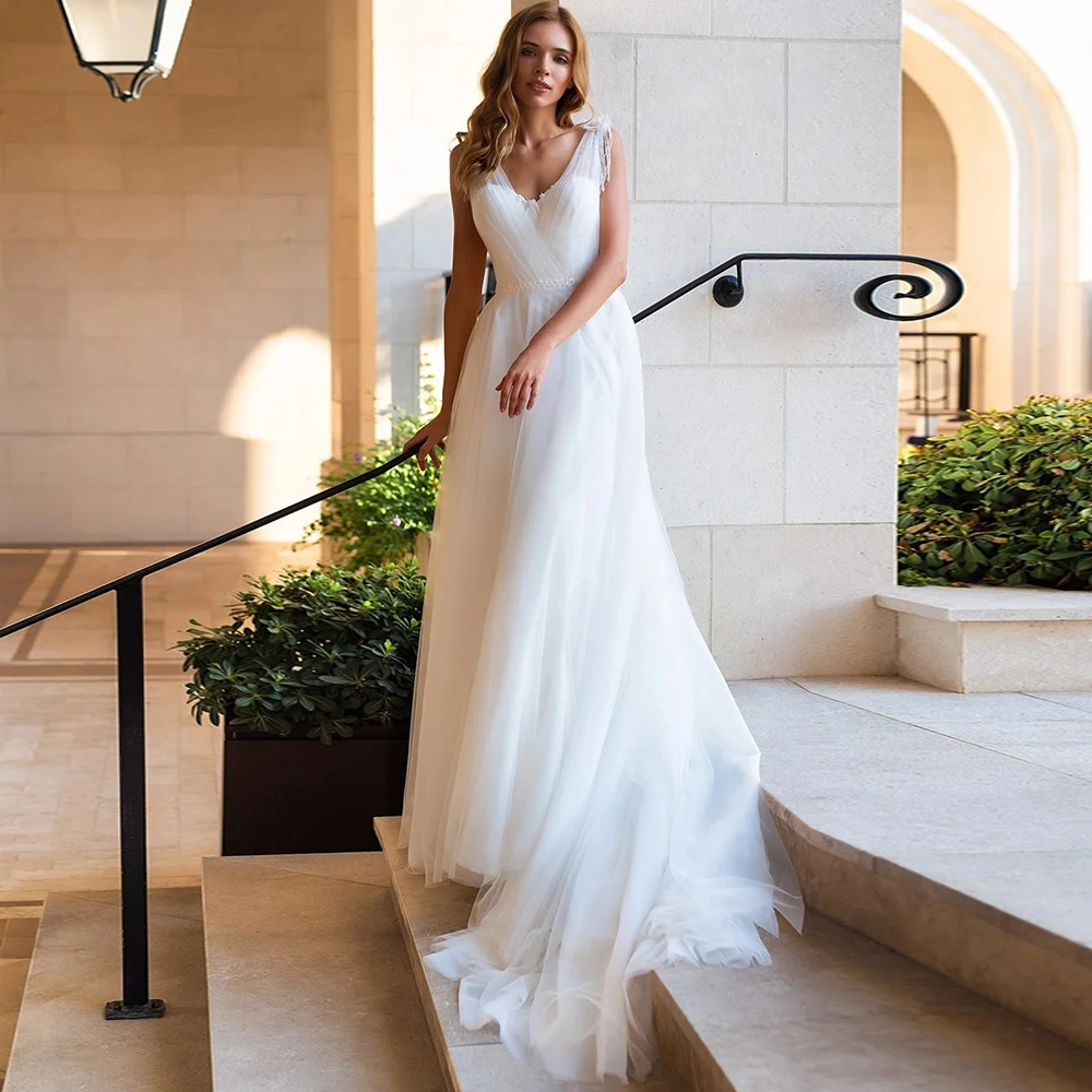 Deep V-Neck Tulle A Line Wedding Dress With Sweep Train Customized Spaghetti Strap Pearl Tassel 3D Floral Modern Bridal Gowns
Deep V-Neck Tulle A Line Wedding Dress With Sweep Train Customized Spaghetti Strap Pearl Tassel 3D Floral Modern Bridal Gowns