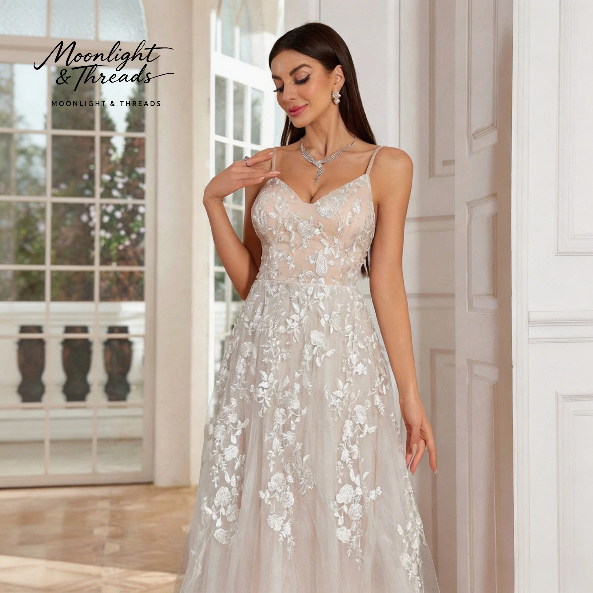 Ivory sleeveless floor-length formal wedding gown with spaghetti straps a full skirt and embroidered appliqués
Ivory sleeveless floor-length formal wedding gown with spaghetti straps a full skirt and embroidered appliqués