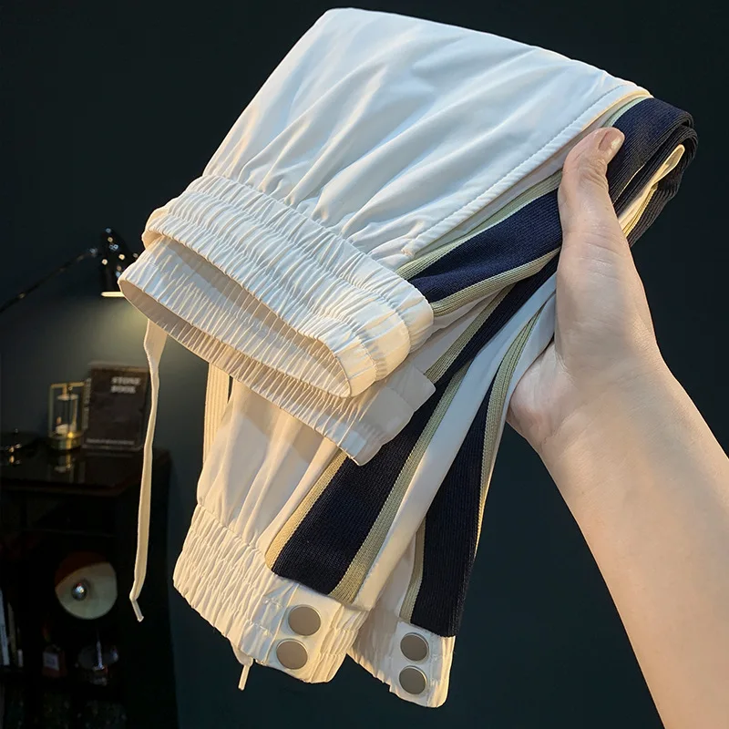 White ultra-thin ice silk pants for men in the summer of 2025, new loose leg binding trend, woven belt splicing casual pants
White ultra-thin ice silk pants for men in the summer of 2025, new loose leg binding trend, woven belt splicing casual pants