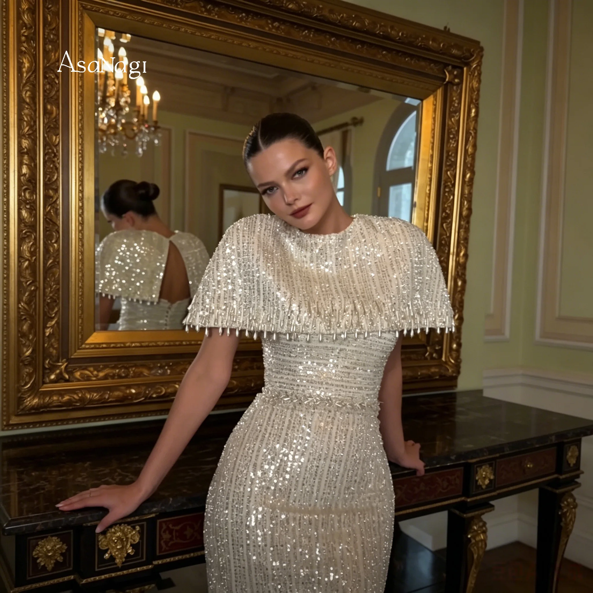 Ivory strapless sleeveless floor-length mermaid formal gown featuring sequins fringe and a matching cropped jacket
Ivory strapless sleeveless floor-length mermaid formal gown featuring sequins fringe and a matching cropped jacket