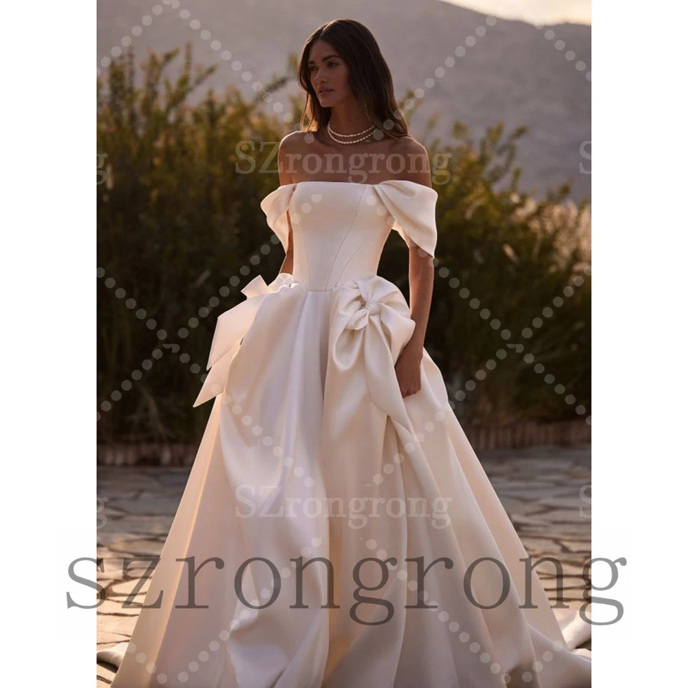 Custom Made Modern Off Shoulder Satin Wedding Dress Bow A-line High Quality Backless Floor Length Bridal Dress with Court
Custom Made Modern Off Shoulder Satin Wedding Dress Bow A-line High Quality Backless Floor Length Bridal Dress with Court