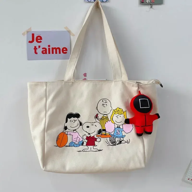 Сумка на плечо для девочек Snoopy, парусиновая студенческая сумка на молнии, милая сумка для хранения с героями мультфильмов, сумка для покупок
Сумка на плечо для девочек Snoopy, парусиновая студенческая сумка на молнии, милая сумка для хранения с героями мультфильмов, сумка для покупок
