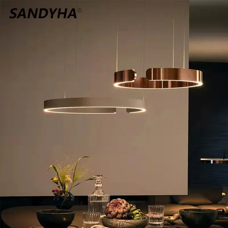 Современные креативные C-образные кольцевые люстры SANDYHA, светодиодная лампа для столовой, гостиной, блеск, салонный декор, подвесные светильники, освещение
Современные креативные C-образные кольцевые люстры SANDYHA, светодиодная лампа для столовой, гостиной, блеск, салонный декор, подвесные светильники, освещение