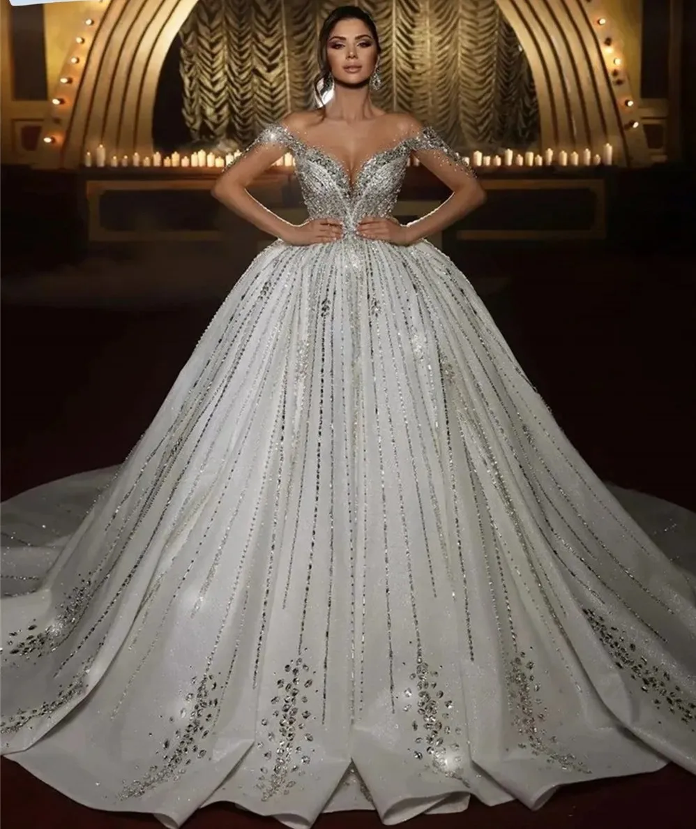 2025 Sparkly Sequins Wedding Dress Sheer Neck Long Sleeves Beads Crystal Bride Bridal Gown Arabic Vestidos De Noiva Customized
2025 Sparkly Sequins Wedding Dress Sheer Neck Long Sleeves Beads Crystal Bride Bridal Gown Arabic Vestidos De Noiva Customized
