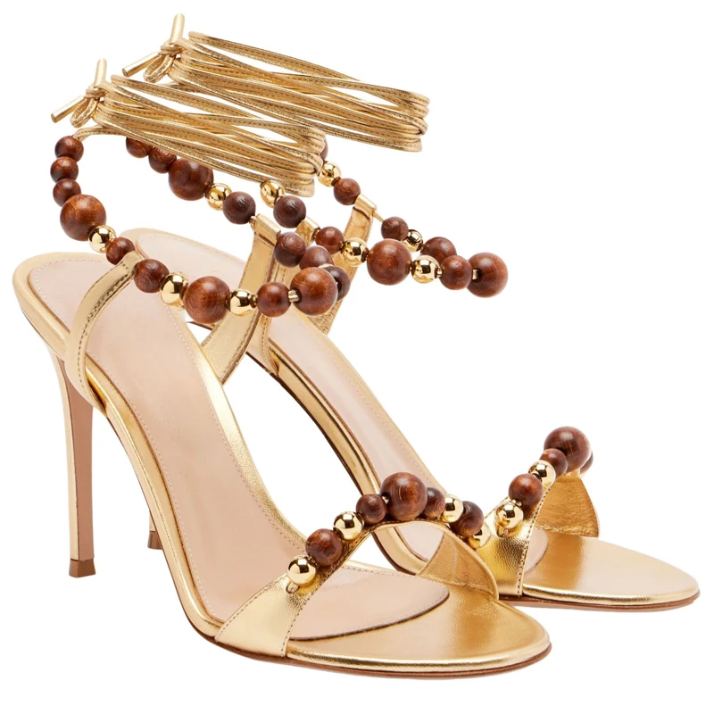 Gold Wooden Bead Lace-Up Open Toe Stiletto Heel Sandals Woman Summer 2026 Ankle Wrap Slingback High Heels for Party Wedding
Gold Wooden Bead Lace-Up Open Toe Stiletto Heel Sandals Woman Summer 2026 Ankle Wrap Slingback High Heels for Party Wedding