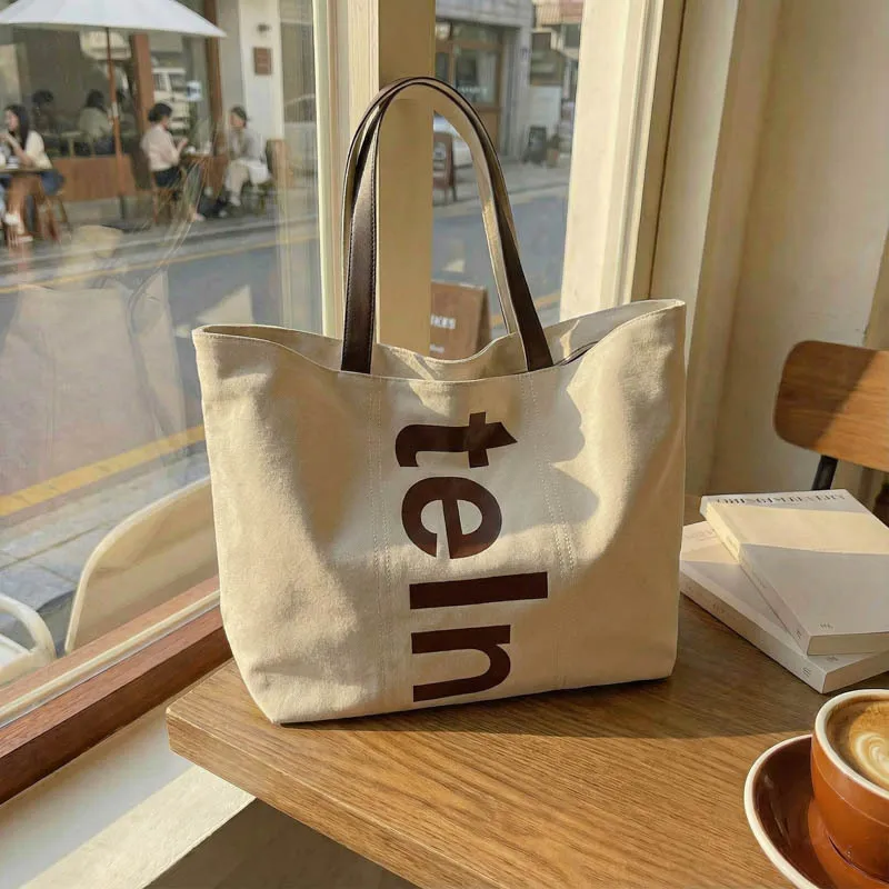 Korean Shoulder Bag Large Capacity Canvas Tote Bag for Women with Letter Print Comfortable and Versatile Texture Storage Bags
Korean Shoulder Bag Large Capacity Canvas Tote Bag for Women with Letter Print Comfortable and Versatile Texture Storage Bags