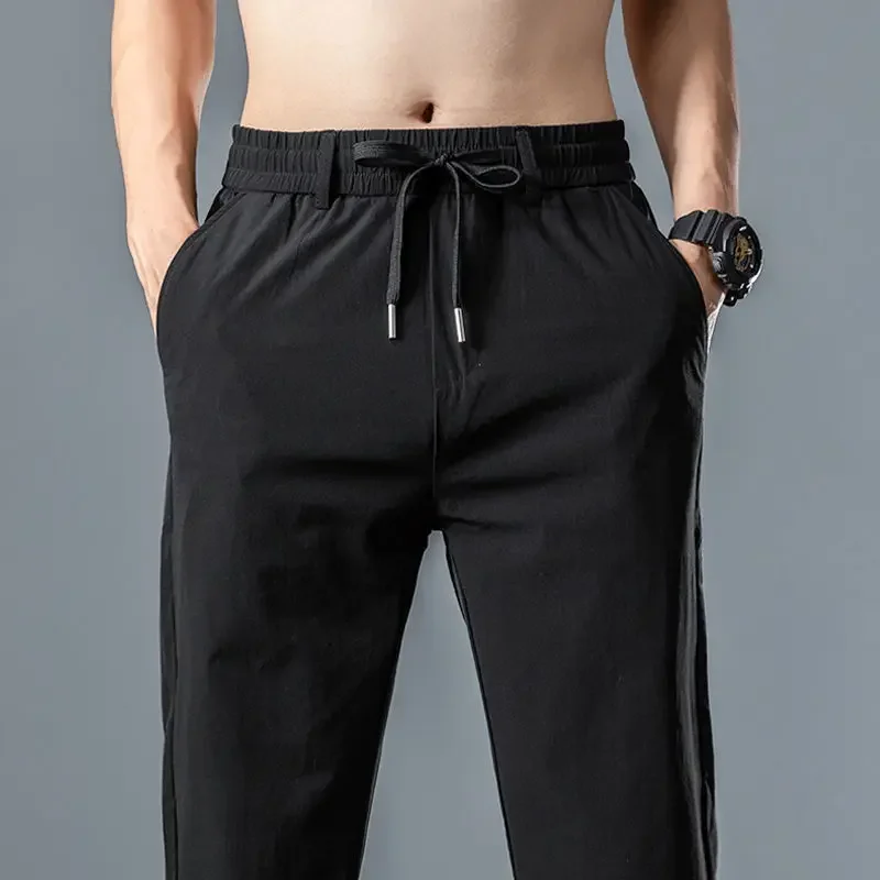 Летние универсальные эластичные быстросохнущие повседневные брюки мужские однотонные свободные прямые брюки с эластичной резинкой на талии и карманами на шнурке JJ235 
Летние универсальные эластичные быстросохнущие повседневные брюки мужские однотонные свободные прямые брюки с эластичной резинкой на талии и карманами на шнурке JJ235