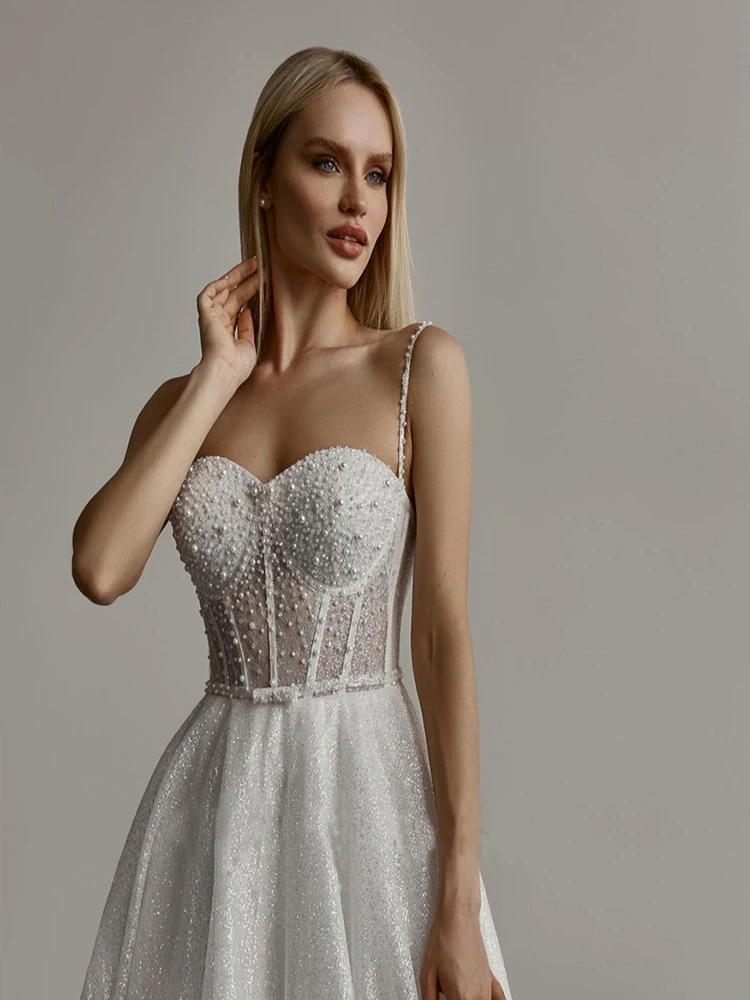 Pearl Embellished A Line Wedding Dress with Delicate Spaghetti Straps and Sparkling Bling Bling Bridal Gowns
Pearl Embellished A Line Wedding Dress with Delicate Spaghetti Straps and Sparkling Bling Bling Bridal Gowns