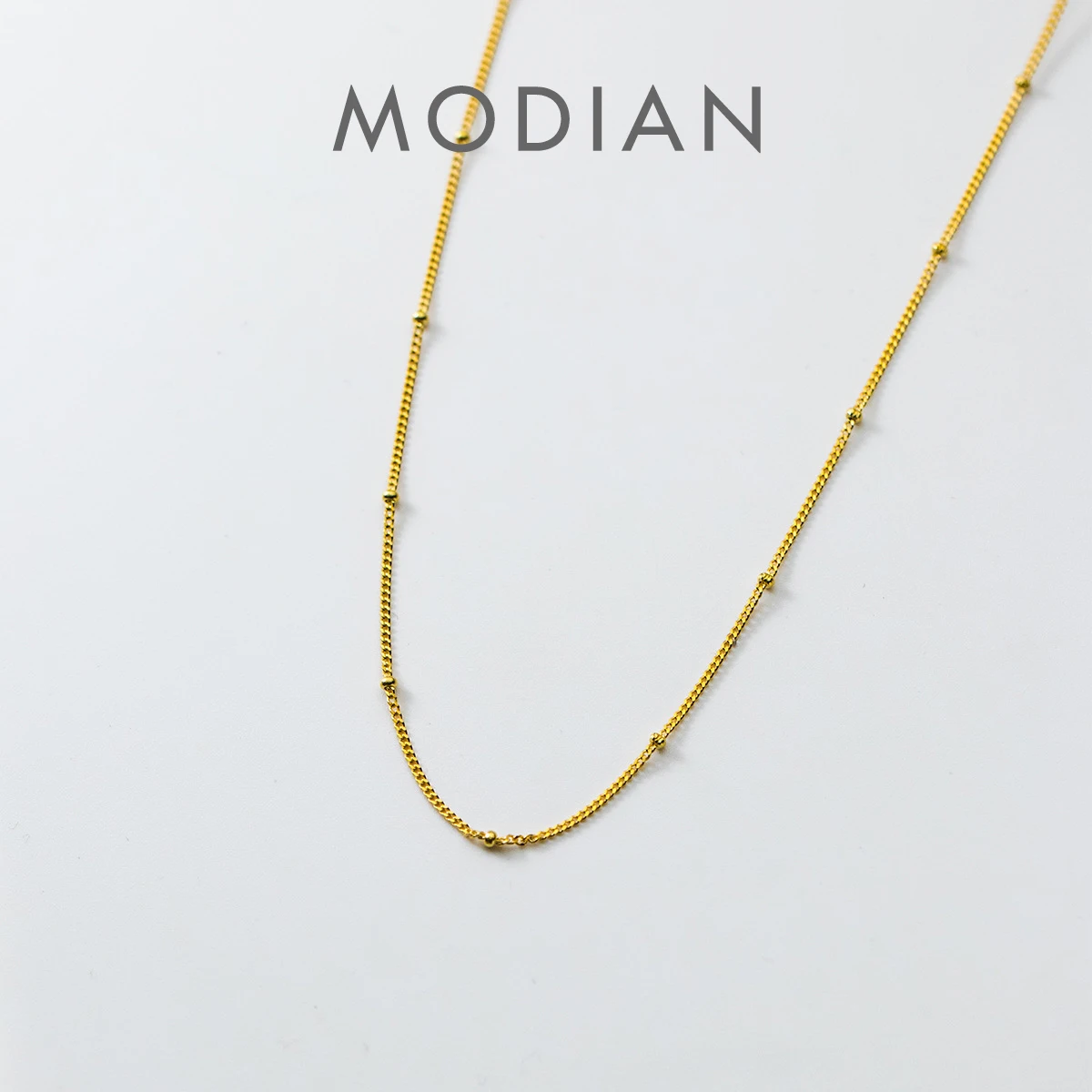 Чокер Modian простого дизайна для женщин, колье из стерлингового серебра 925 пробы с легкими бусинами, изящная цепочка без украшений, хороший подарок, 3 цвета
Чокер Modian простого дизайна для женщин, колье из стерлингового серебра 925 пробы с легкими бусинами, изящная цепочка без украшений, хороший подарок, 3 цвета