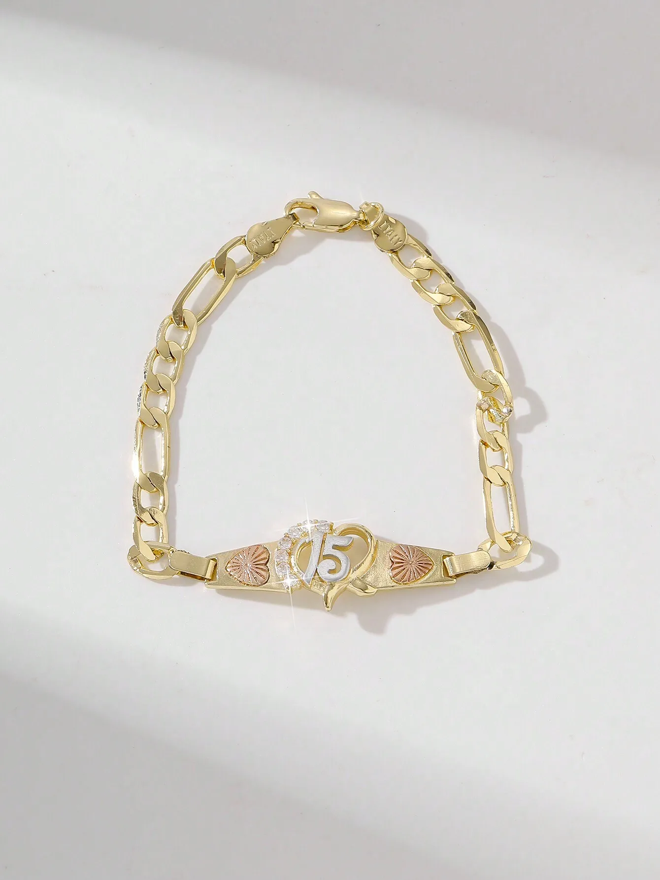 Gold-Tone Figaro Chain Bracelet with Number 15 Heart Charm and Rose Gold Accents
Gold-Tone Figaro Chain Bracelet with Number 15 Heart Charm and Rose Gold Accents