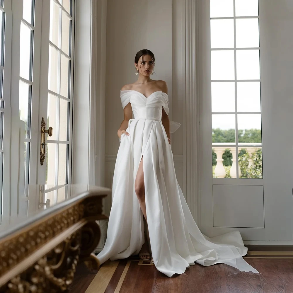 Elegant A-line Bow Split with Pockets Court Wedding Gown Off the Shoulder Satin Pleated Wedding Dress for Women
Elegant A-line Bow Split with Pockets Court Wedding Gown Off the Shoulder Satin Pleated Wedding Dress for Women