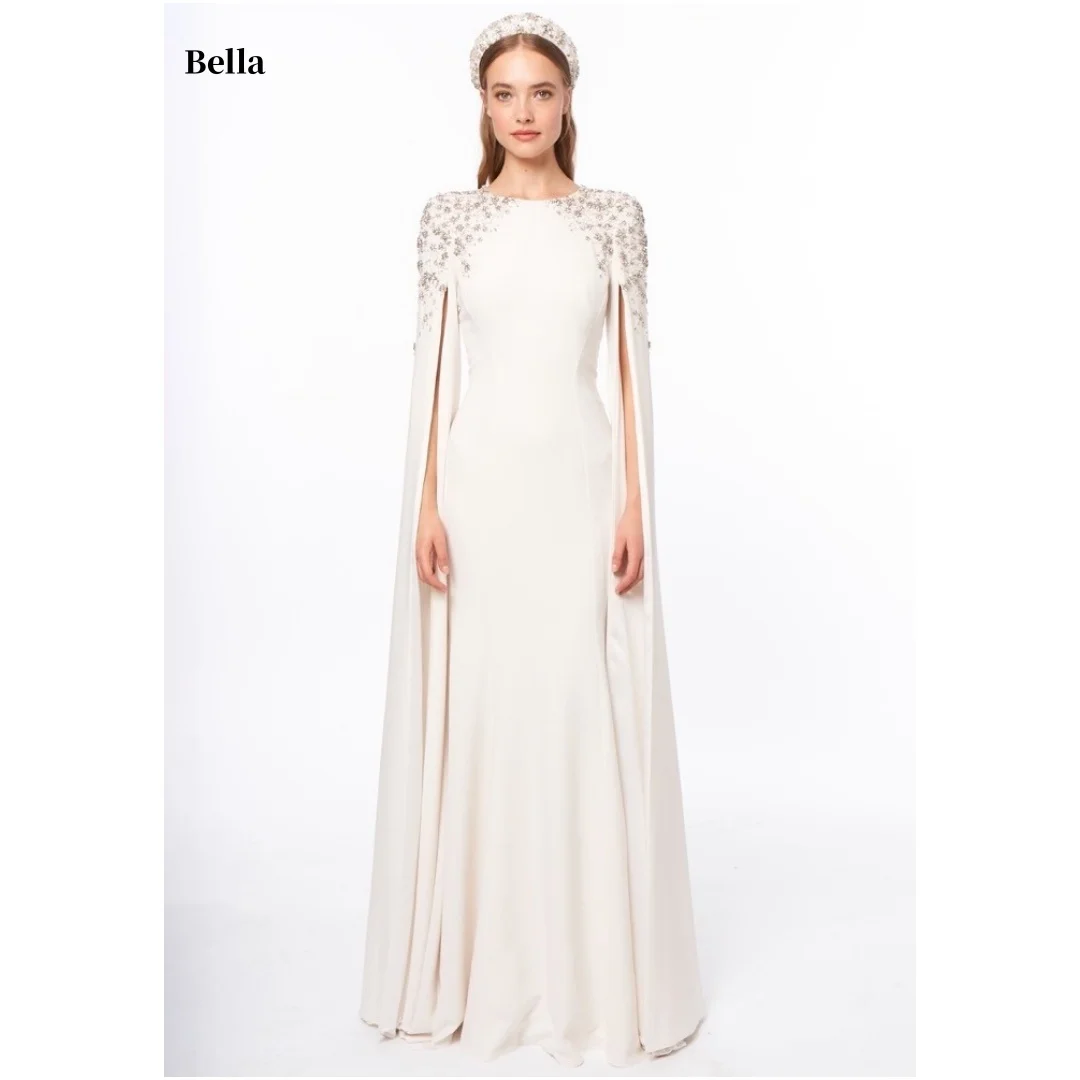 Bella Индивидуальные длинные накидки цвета слоновой кости с круглым вырезом и бисером на плечах, облегающие макси-халаты для вечеринок, элегантные вечерние платья, торжественное платье для выпускного вечера
Bella Индивидуальные длинные накидки цвета слоновой кости с круглым вырезом и бисером на плечах, облегающие макси-халаты для вечеринок, элегантные вечерние платья, торжественное платье для выпускного вечера