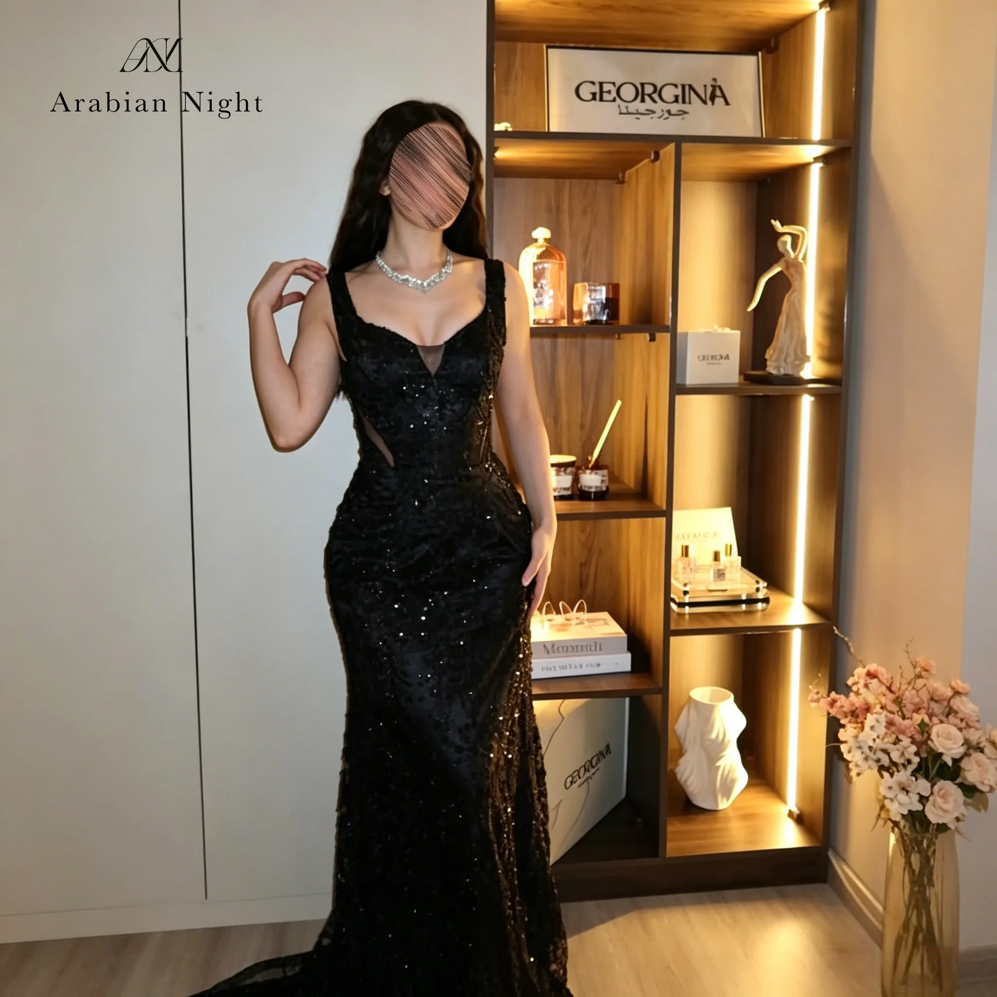 Elegant black spaghetti strap mermaid gown with lace details, perfect for formal occasions and balls.
Elegant black spaghetti strap mermaid gown with lace details, perfect for formal occasions and balls.