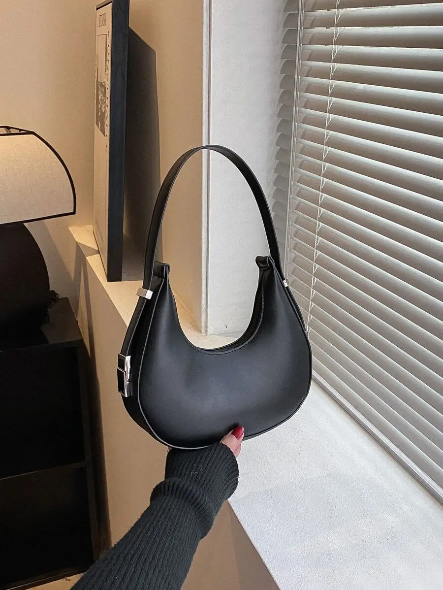 Minimalist Solid Black Crescent-Shaped Shoulder Bag with Silver Hardware
Minimalist Solid Black Crescent-Shaped Shoulder Bag with Silver Hardware