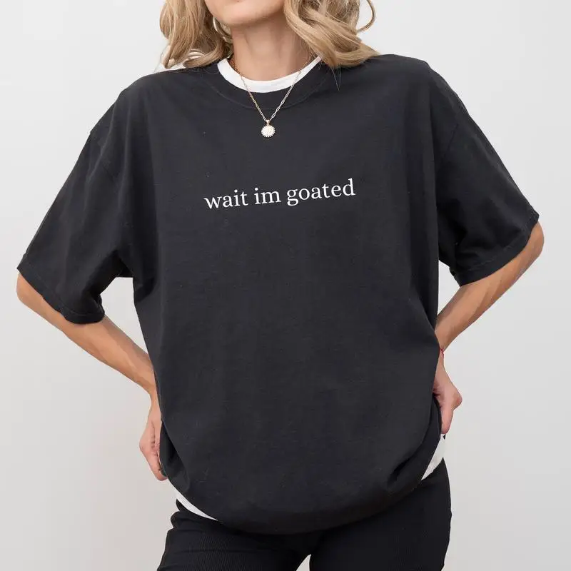 Wait I'm Goated T-shirt, Funny Meme Graphic Tee, Women's Oversized Sarcastic Quote Tops, Cool Streetwear Outfits
Wait I'm Goated T-shirt, Funny Meme Graphic Tee, Women's Oversized Sarcastic Quote Tops, Cool Streetwear Outfits