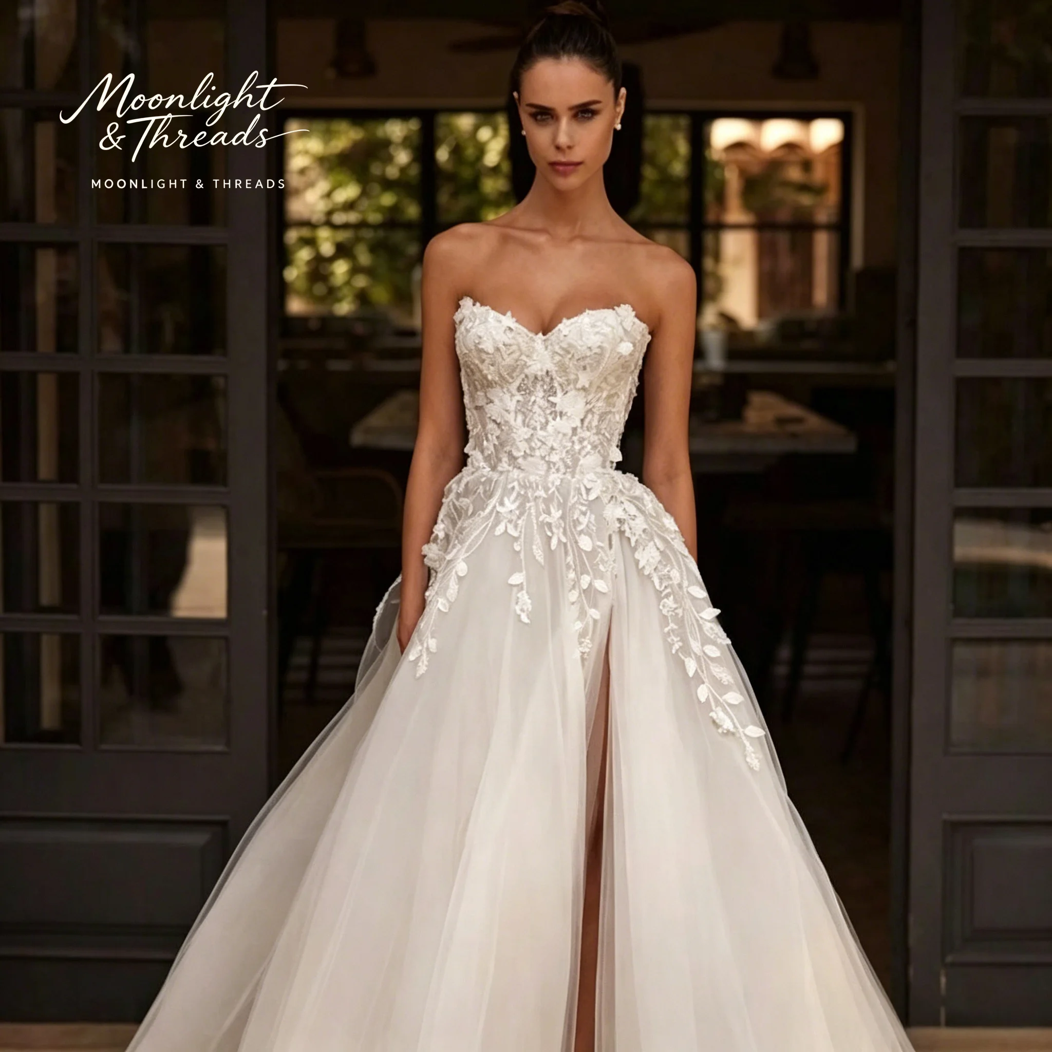 Ivory strapless A-line formal wedding gown featuring an embroidered bodice with internal boning and a skirt with a high slit
Ivory strapless A-line formal wedding gown featuring an embroidered bodice with internal boning and a skirt with a high slit