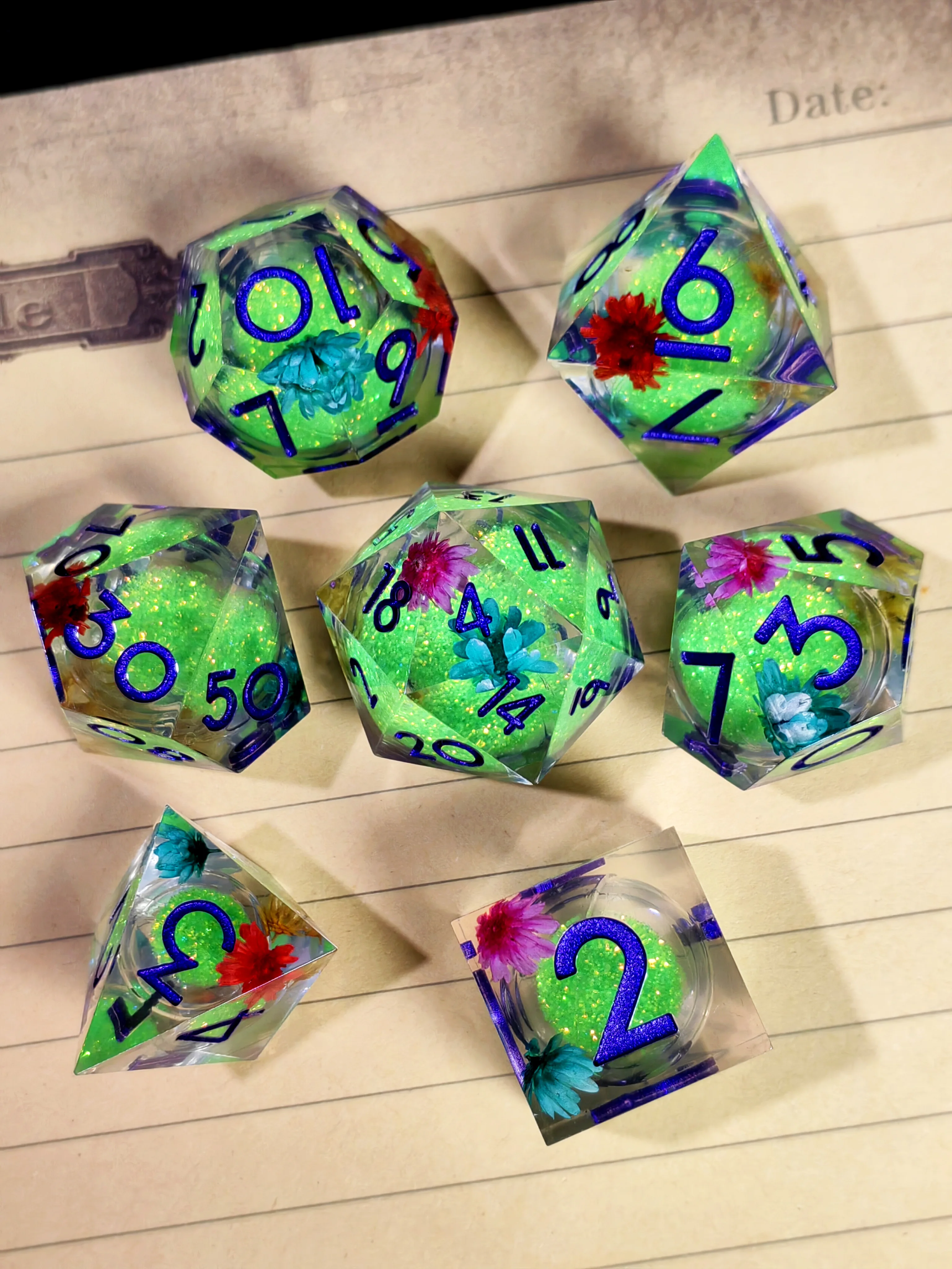 DnD Dice Set - 7pcs Sharp Edge Resin Dice, Green Sand with Flower Pattern, Transparent Base Blue Numbers, for D&D, RPG Games
DnD Dice Set - 7pcs Sharp Edge Resin Dice, Green Sand with Flower Pattern, Transparent Base Blue Numbers, for D&D, RPG Games