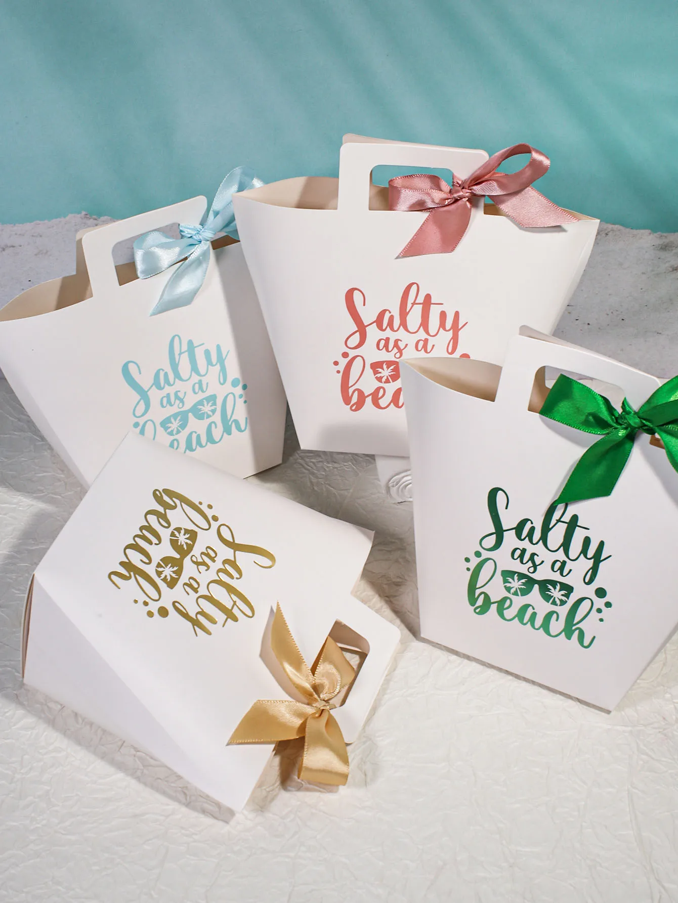 Summer candy box, party decoration beach inspired gift box, colorful ribbons, with the playful phrase 'beach salty'.
Summer candy box, party decoration beach inspired gift box, colorful ribbons, with the playful phrase 'beach salty'.