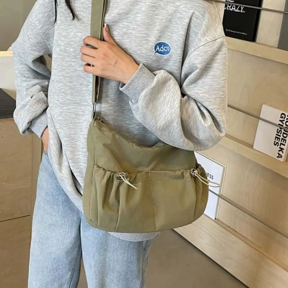Korean Style Drawstring Pocket Crossbody Bag Large Capacity Niche Design Light Soft Nylon Bag Solid Color Tote Bag Shoulder Bag
Korean Style Drawstring Pocket Crossbody Bag Large Capacity Niche Design Light Soft Nylon Bag Solid Color Tote Bag Shoulder Bag