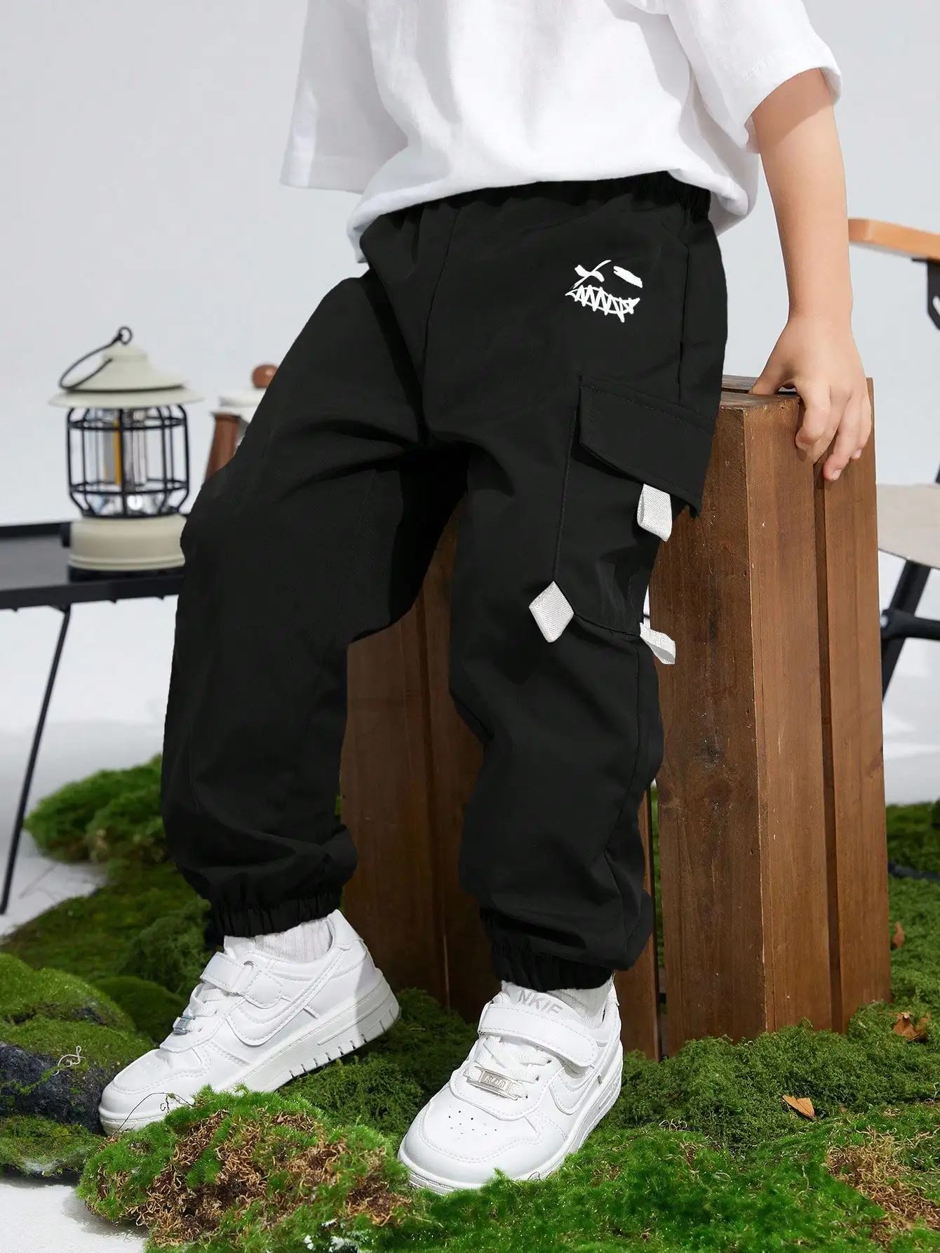 Kids Black Loose Fit Cargo Pants with Graphic Print and Utility Pockets
Kids Black Loose Fit Cargo Pants with Graphic Print and Utility Pockets