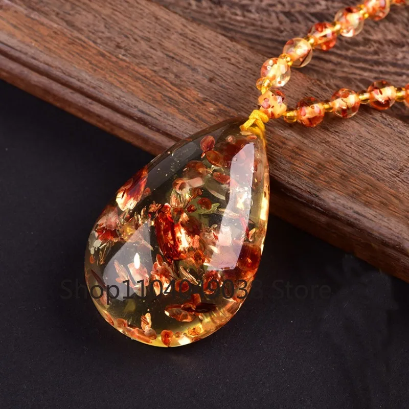 Ожерелье-подвеска в форме цветка с каплей воды, из медового воска и янтаря, для мужчин и женщин
Ожерелье-подвеска в форме цветка с каплей воды, из медового воска и янтаря, для мужчин и женщин