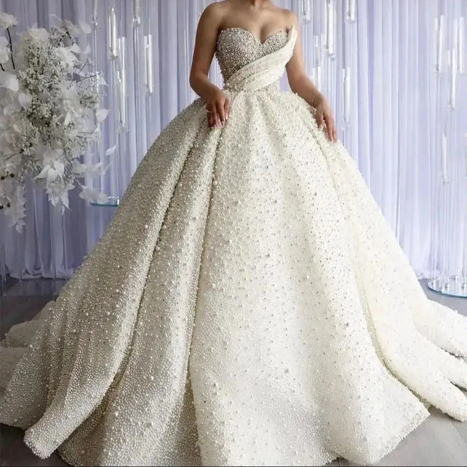 2026 Dubai Luxury Pearls Beading Sweetheart Ball Gown Wedding Dresses Princess Sleeveless Bride Gowns Vestido De Noiva Custom
2026 Dubai Luxury Pearls Beading Sweetheart Ball Gown Wedding Dresses Princess Sleeveless Bride Gowns Vestido De Noiva Custom