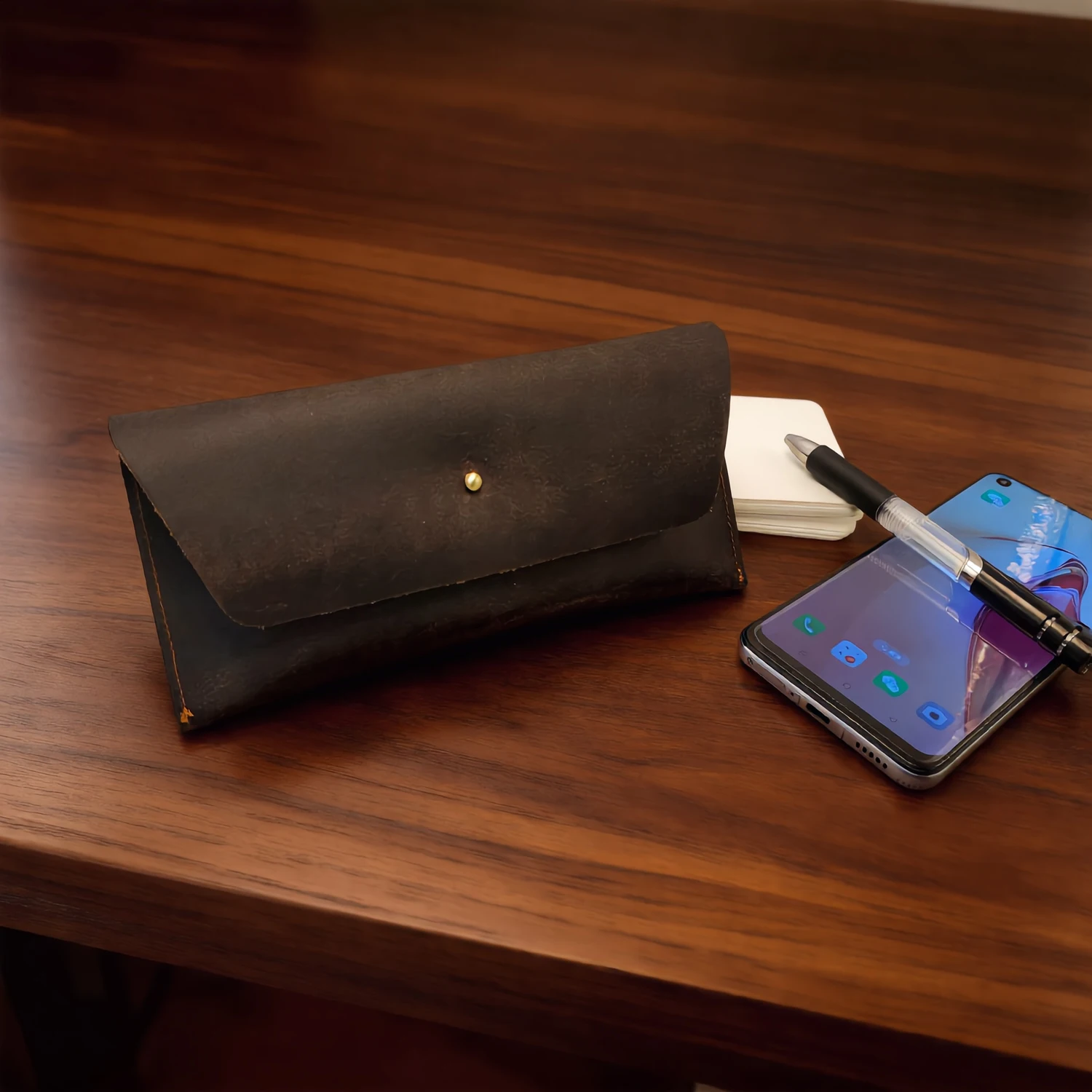 This dark brown clutch bag, crafted from vintage Crazy Horse leather, engages in a dialogue of pure aesthetics through its minim
This dark brown clutch bag, crafted from vintage Crazy Horse leather, engages in a dialogue of pure aesthetics through its minim