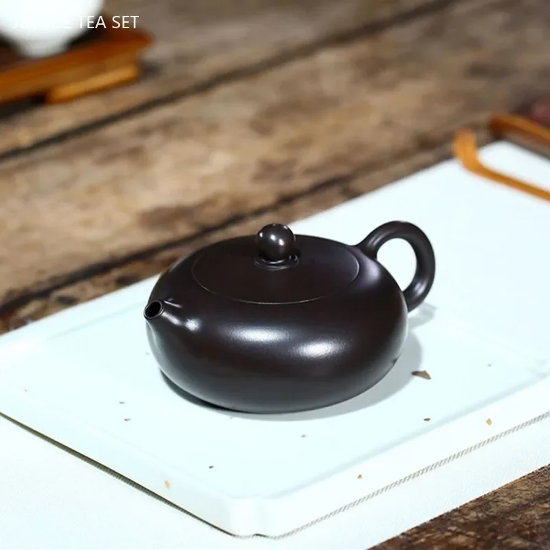 160ml Chinese Yixing Purple Clay Tea Pot Boutique Black Mud Flat Xishi Teapot Home 9 Hole Filter Teaware Customized Tea Infuser
160ml Chinese Yixing Purple Clay Tea Pot Boutique Black Mud Flat Xishi Teapot Home 9 Hole Filter Teaware Customized Tea Infuser