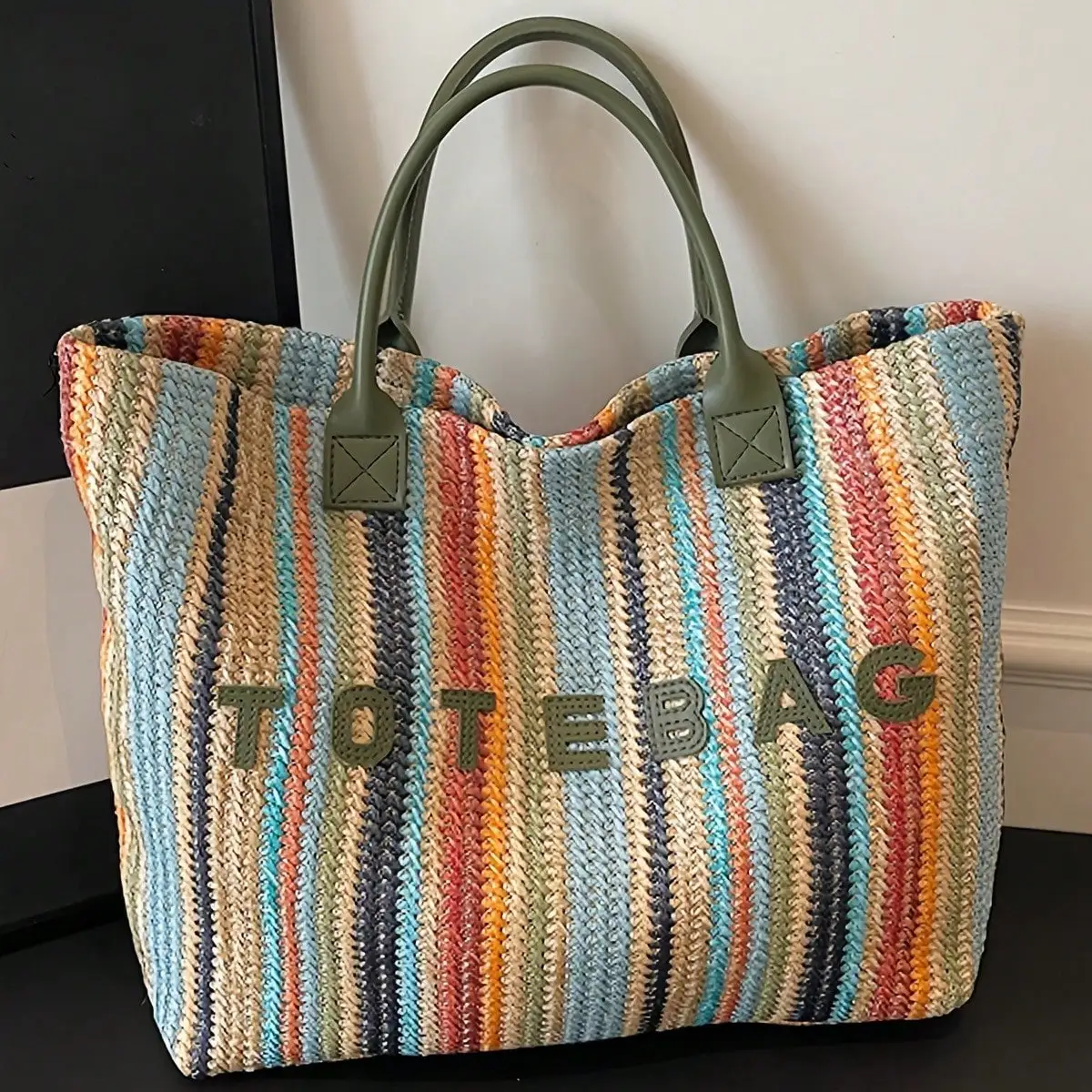This stylish, colorful striped straw tote bag features a bohemian-style handwoven letter pattern and contrasting colors. A versatile and simple shoulder bag, perfect for summer beach vacations, everyday outings, or shopping.
This stylish, colorful striped straw tote bag features a bohemian-style handwoven letter pattern and contrasting colors. A versatile and simple shoulder bag, perfect for summer beach vacations, everyday outings, or shopping.