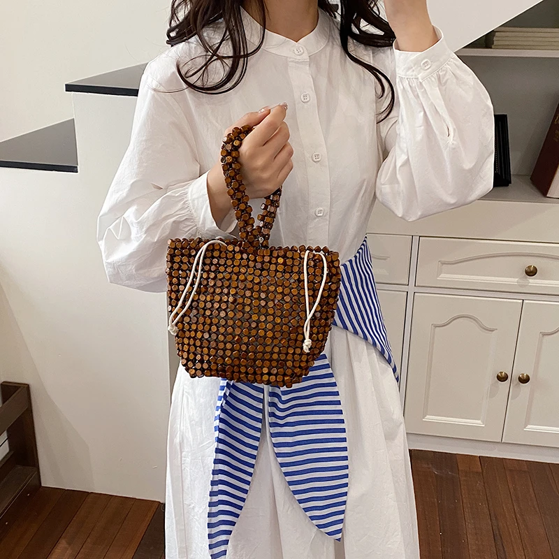 Summer Personality Wooden Beads Tote Bags Hot Sale Retro Beach Handbag for Women Vacation Fashionable Bohemian Style Bucket Bag
Summer Personality Wooden Beads Tote Bags Hot Sale Retro Beach Handbag for Women Vacation Fashionable Bohemian Style Bucket Bag