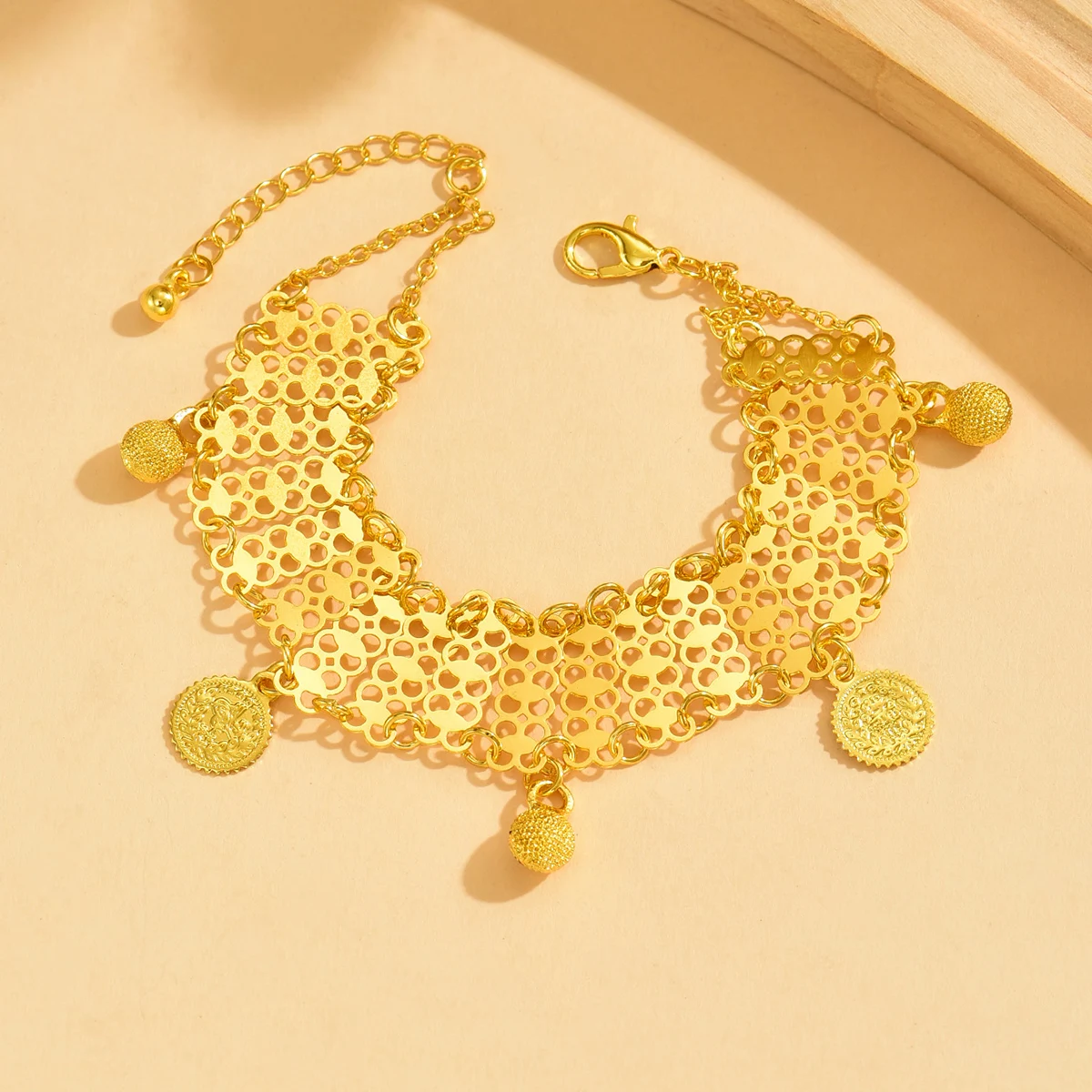 Bohemian Golden Tone Mesh Bracelet Hollow Design with Dangling Coin Ball Pendants Fashion Style Jewelry
Bohemian Golden Tone Mesh Bracelet Hollow Design with Dangling Coin Ball Pendants Fashion Style Jewelry