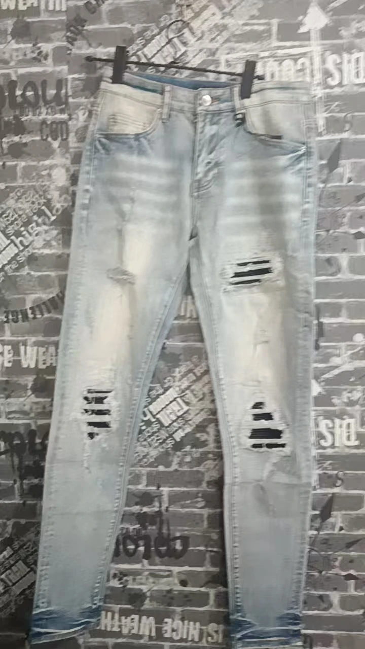American designer men's fashionable new denim jeans washed with nostalgia, perforated patch, elastic tight fit, light blue taper
American designer men's fashionable new denim jeans washed with nostalgia, perforated patch, elastic tight fit, light blue taper