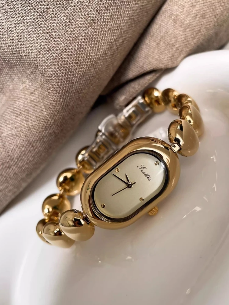 Женские часы в стиле ретро, простые темпераментные овальные кварцевые часы, браслет с кофейными зернами, водонепроницаемые модные темпераментные женские часы
Женские часы в стиле ретро, простые темпераментные овальные кварцевые часы, браслет с кофейными зернами, водонепроницаемые модные темпераментные женские часы