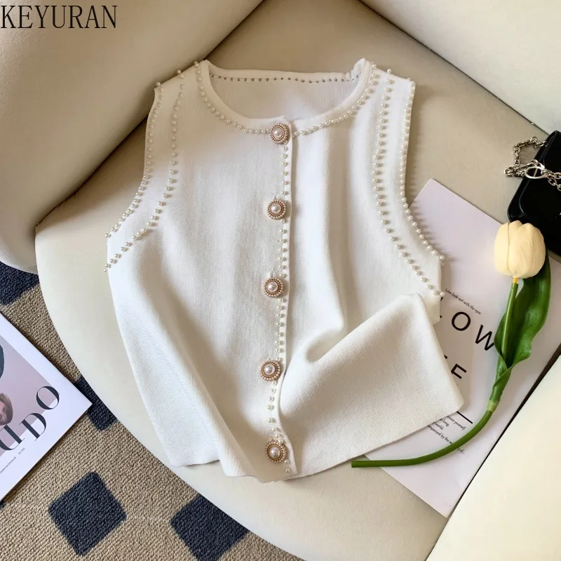 2025 Summer Thin Peals Beading Sleeveless Sweater Knitted Vest Women Chic Round Neck Single Breasted Pullover Knitwear Crop Tops
2025 Summer Thin Peals Beading Sleeveless Sweater Knitted Vest Women Chic Round Neck Single Breasted Pullover Knitwear Crop Tops