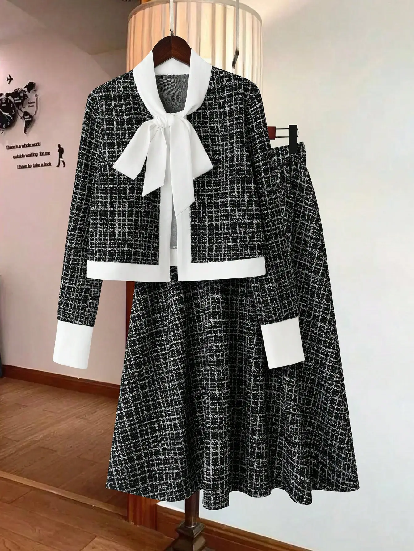 Элегантный черно-белый твидовый костюм с клетчатой юбкой: укороченный блейзер с воротником-бантом и контрастной отделкой, расклешенная юбка. Формальная деловая одежда.
Элегантный черно-белый твидовый костюм с клетчатой юбкой: укороченный блейзер с воротником-бантом и контрастной отделкой, расклешенная юбка. Формальная деловая одежда.