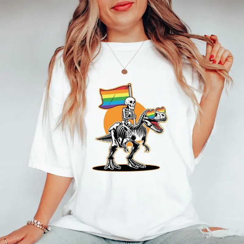 Unisex Pride Month T-Shirt | LGBTQ+ Rainbow Dinosaur Skeleton Graphic Tee | Transgender Ally Dino Rider Gift Top
Unisex Pride Month T-Shirt | LGBTQ+ Rainbow Dinosaur Skeleton Graphic Tee | Transgender Ally Dino Rider Gift Top