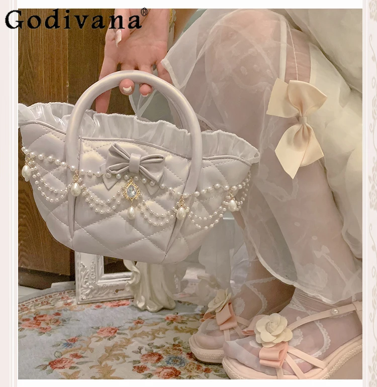 Japanese Original Lolita Pearl Bow Lace Ribbon Handbag Elegant Lady Princess Style Versatile Fashion Shoulder Bag 
Japanese Original Lolita Pearl Bow Lace Ribbon Handbag Elegant Lady Princess Style Versatile Fashion Shoulder Bag