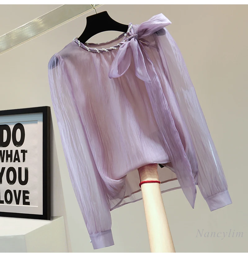 Bow Strap Pullover Purple Chiffon Shirt Ladies 2025 Spring and Summer Loose Solid Color Bead Round Neck Long-sleeved Blouse Tops
Bow Strap Pullover Purple Chiffon Shirt Ladies 2025 Spring and Summer Loose Solid Color Bead Round Neck Long-sleeved Blouse Tops