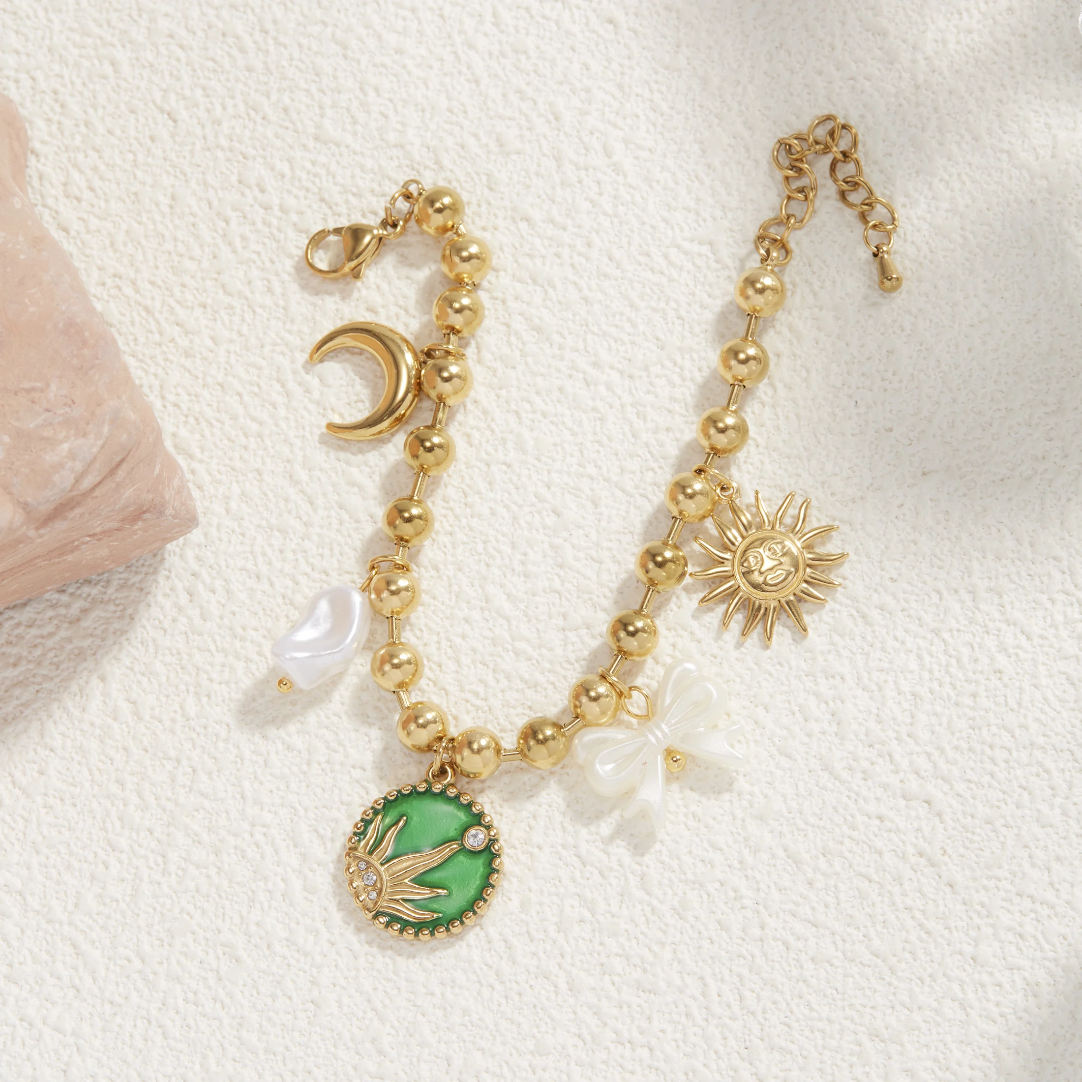 Golden Tone Stainless Steel Sun and Moon Charm Bracelet with Enamel and Synthetic Zirconia for Women
Golden Tone Stainless Steel Sun and Moon Charm Bracelet with Enamel and Synthetic Zirconia for Women