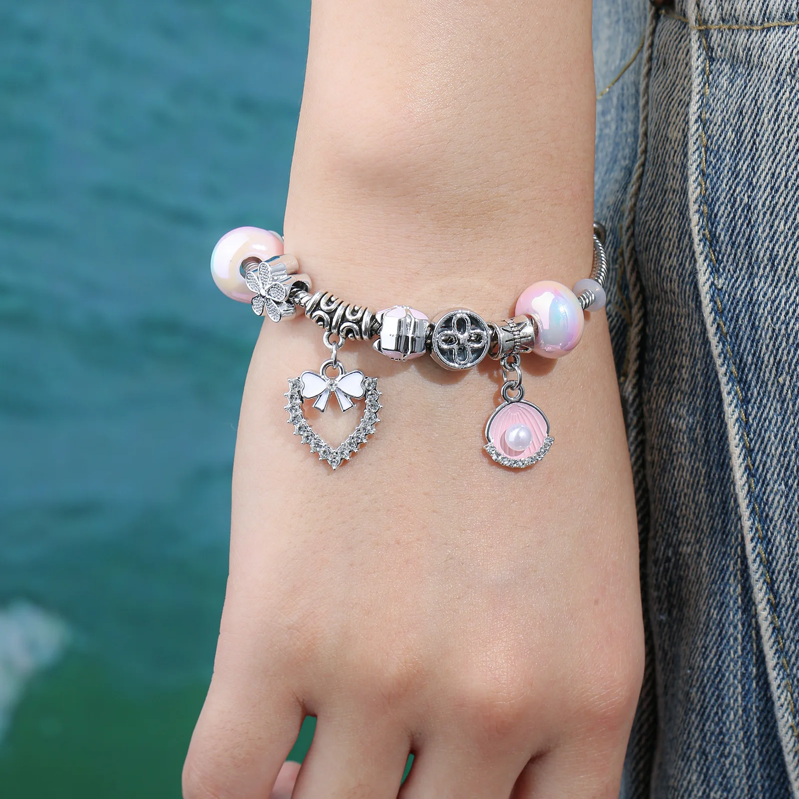 Silver Tone Charm Bracelet with Pink Shell and Bow Heart Pendant for Women
Silver Tone Charm Bracelet with Pink Shell and Bow Heart Pendant for Women