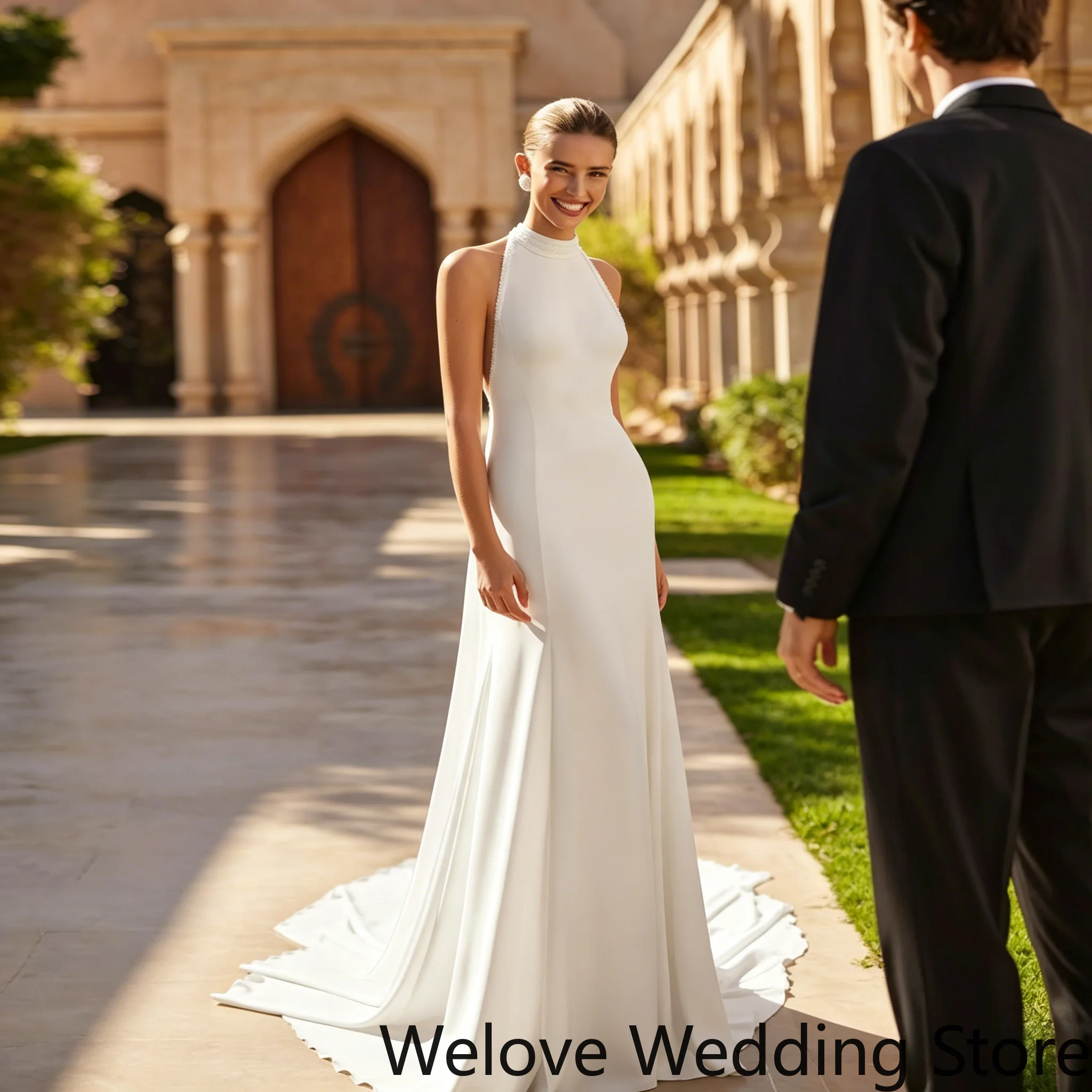 Minimalist White Bridal Gown featuring a sleek halter neckline, form-fitting mermaid silhouette, and elegant open back
Minimalist White Bridal Gown featuring a sleek halter neckline, form-fitting mermaid silhouette, and elegant open back