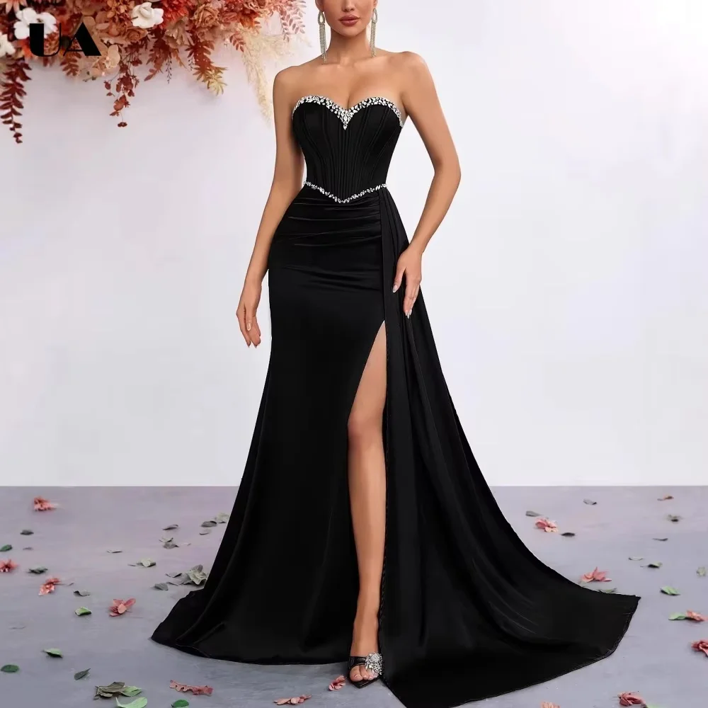 Classic black strapless evening gown with cinched waist and mini train. Sculpting fit flatters body curves, front slit adds styl
Classic black strapless evening gown with cinched waist and mini train. Sculpting fit flatters body curves, front slit adds styl
